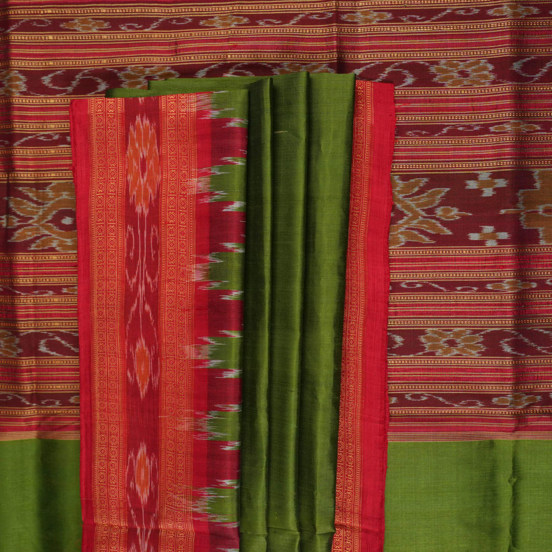 Model draped in a green and red Khandua silk saree with traditional butta work and rich border.