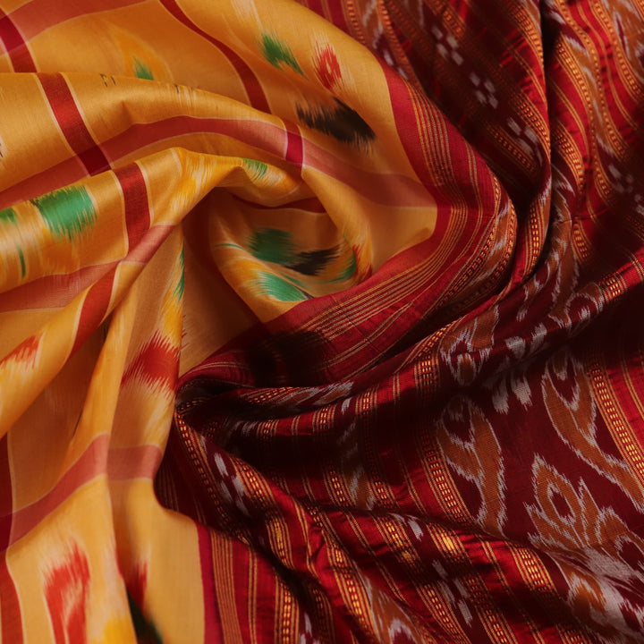 Saree draped to showcase the Nabakothi pattern, red border, and multi-colored silk Khandua handloom artistry.