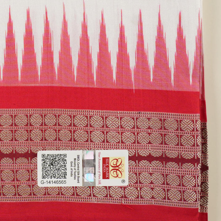 Extreme close-up revealing the rich Bomkai silk fabric texture and intricate handloom weave details in white and red.