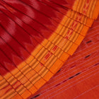 Red and yellow Sambalpuri cotton saree with motifs, elegantly draped to showcase its style.
