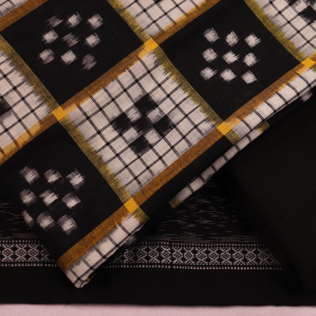 Close-up view of a black and white Sambalpuri cotton blouse piece with a Pasapalli pattern.