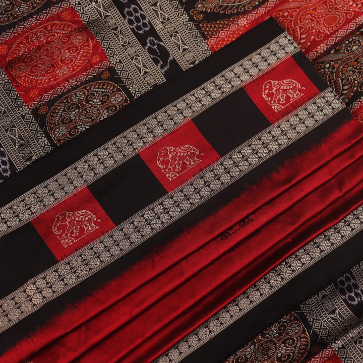 Detailed texture of handwoven Bomkai silk saree fabric in maroon and black with butta pattern.
