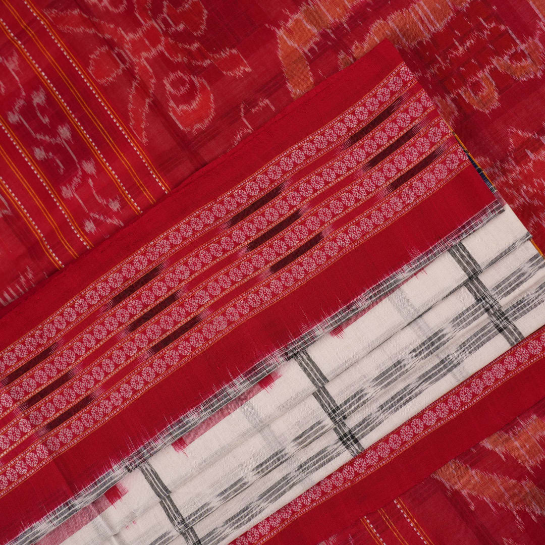 Model wearing a white and red Sambalpuri cotton saree with traditional motifs, styled for an elegant look.