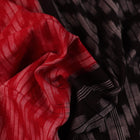 Red and black Sambalpuri cotton saree with motifs, elegantly draped.