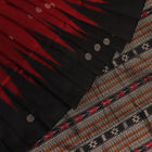 Close-up texture of handwoven Bomkai silk saree fabric: maroon and black threads forming butta pattern.