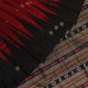 Close-up texture of handwoven Bomkai silk saree fabric: maroon and black threads forming butta pattern.