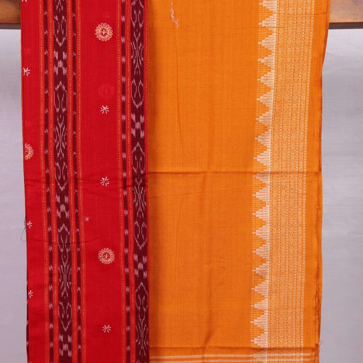 Close-up view of a red and yellow cotton Sambalpuri dress material with intricate motif patterns