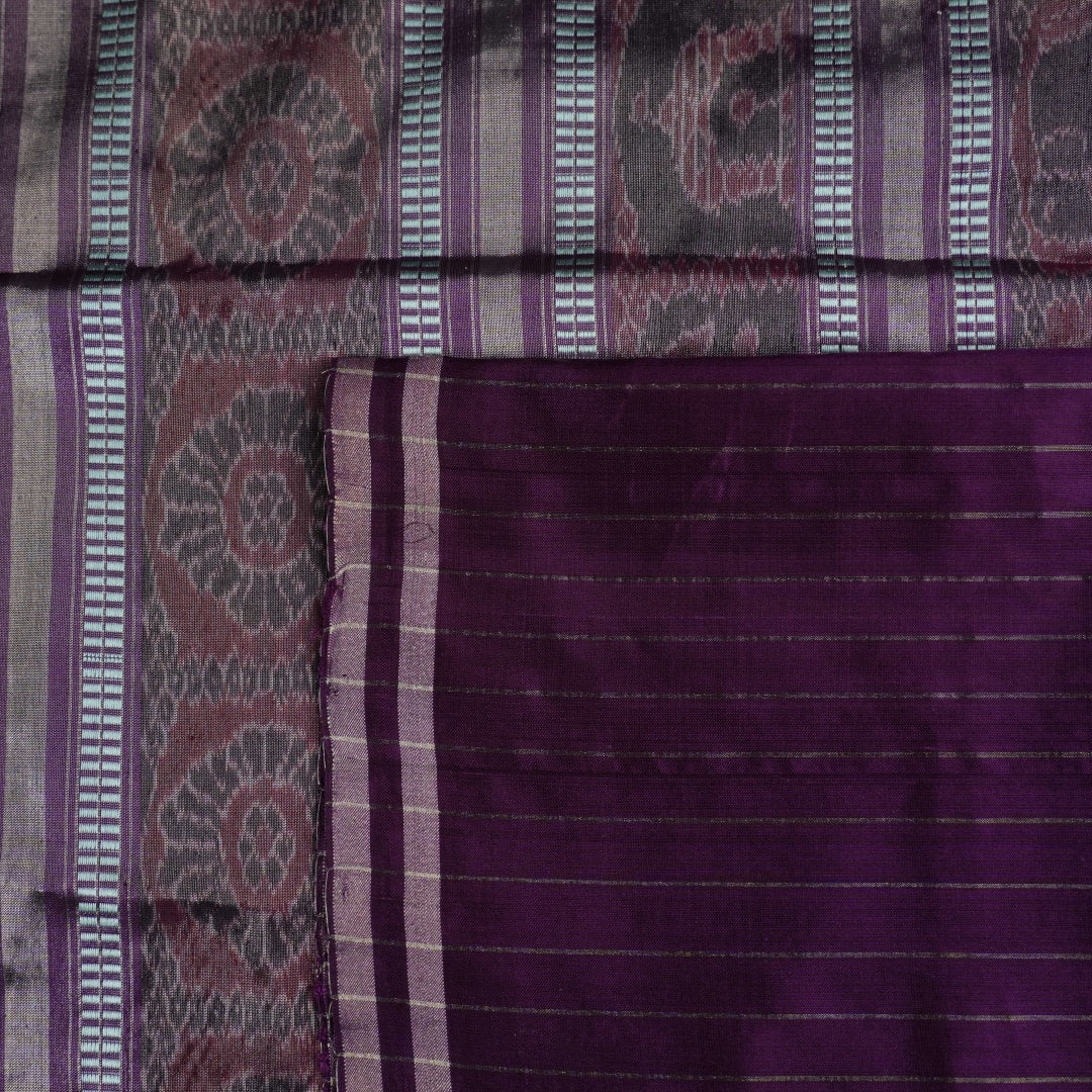 Ultra close-up of the luxurious green Sambalpuri handloom silk weave, highlighting its smooth texture.