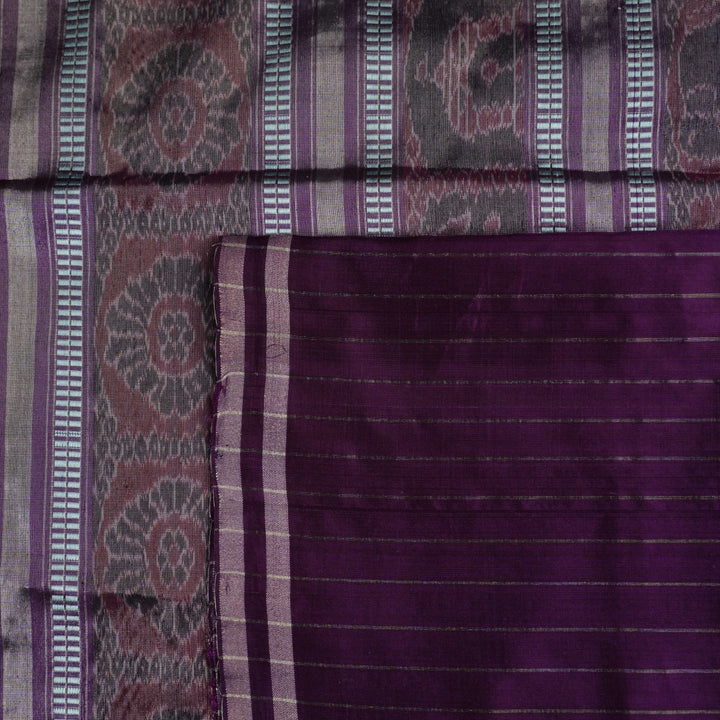 Ultra close-up of the luxurious green Sambalpuri handloom silk weave, highlighting its smooth texture.