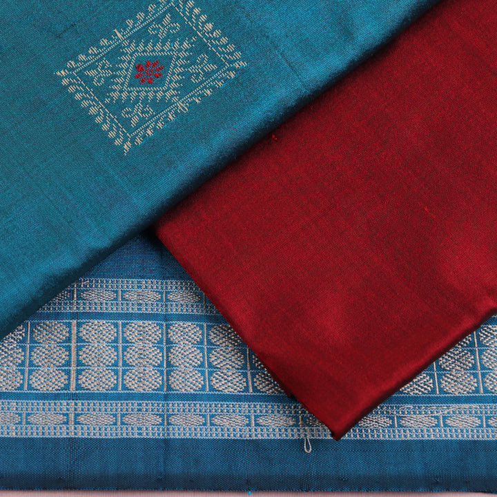 Detail of blue Bomkai silk dress material blouse piece with maroon butta.