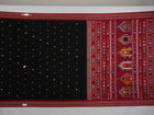 Full view of the black and red Dolabedi cotton saree laid out to show the complete pattern and pallu.