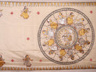 Close-up of white silk Patachitra saree, showcasing the handloom fabric's texture and subtle paint details.