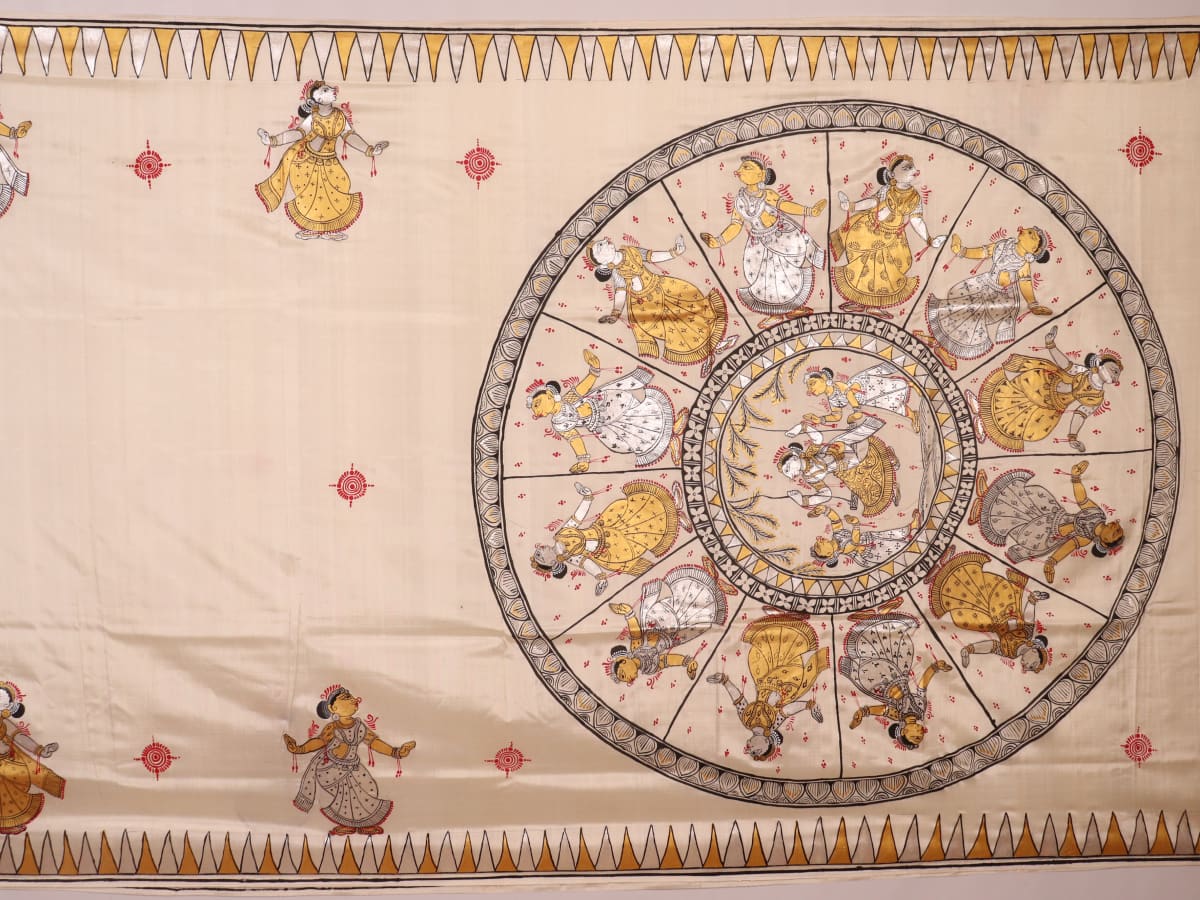 Close-up of white silk Patachitra saree, showcasing the handloom fabric's texture and subtle paint details.
