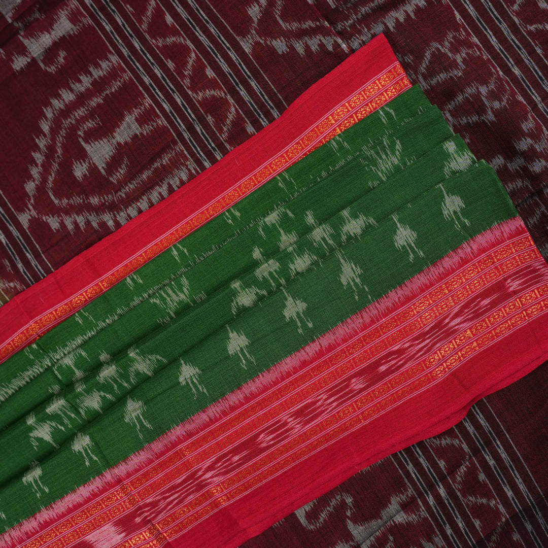 Model draped in a green and red Sambalpuri cotton saree with traditional motifs, styled for a classic look.