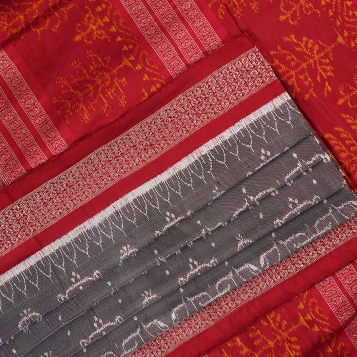 Close-up of the soft, lustrous grey Sambalpuri silk fabric texture, highlighting the intricate weave and motifs.