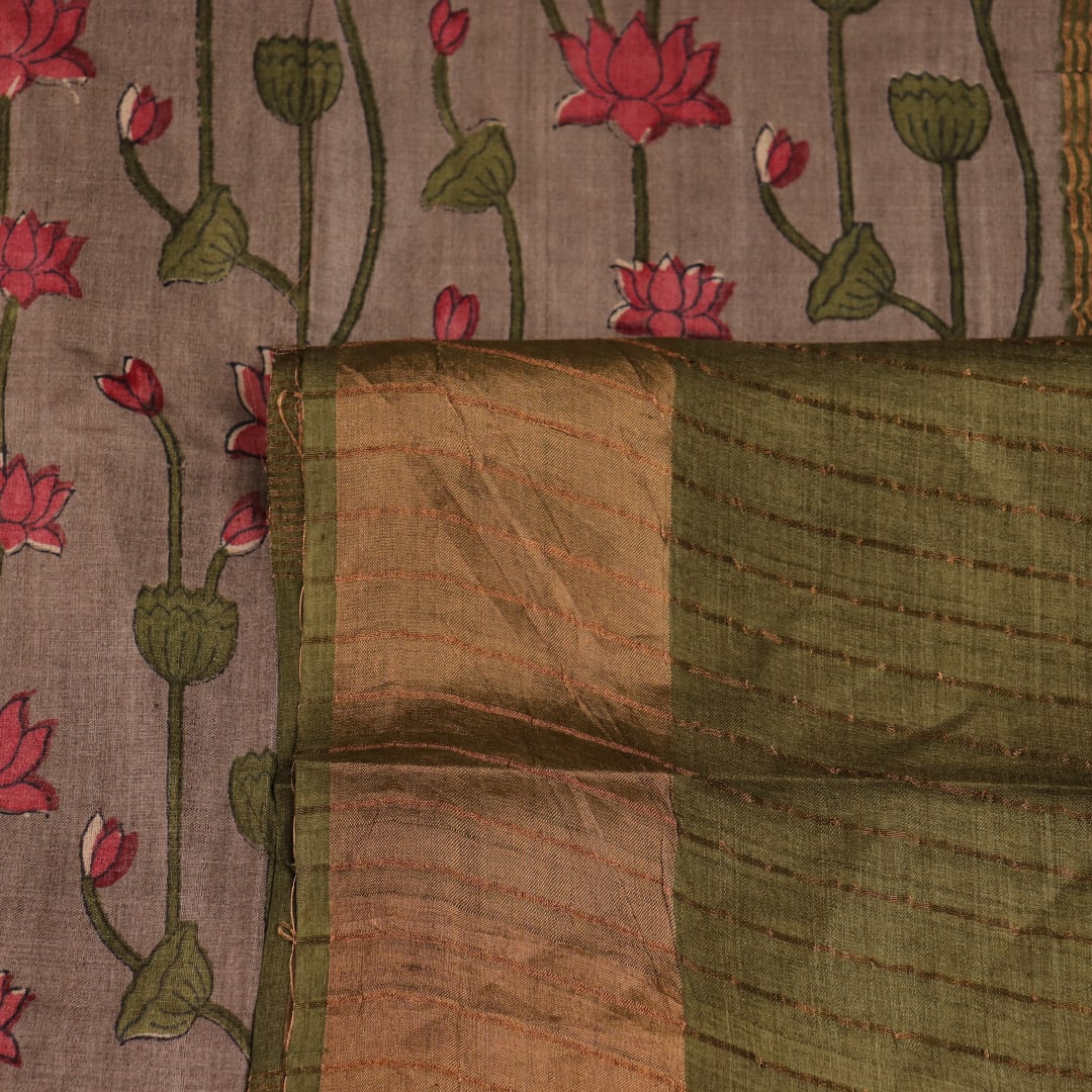 Close-up view of grey Tussar silk saree with intricate motifs on its textured fabric