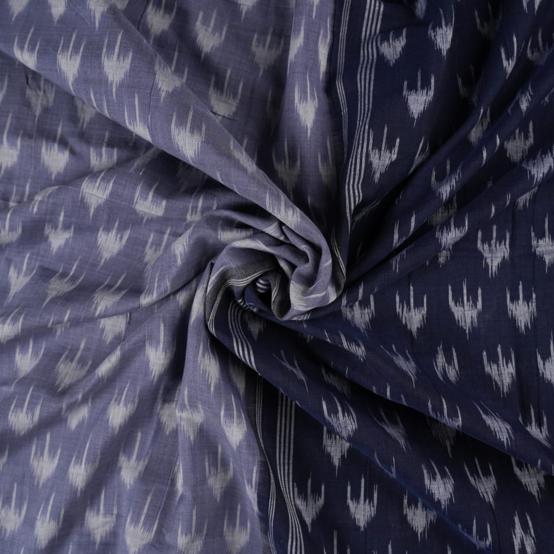 Model wearing a grey and black Sambalpuri cotton saree with traditional ikat motifs in a classic ethnic drape.