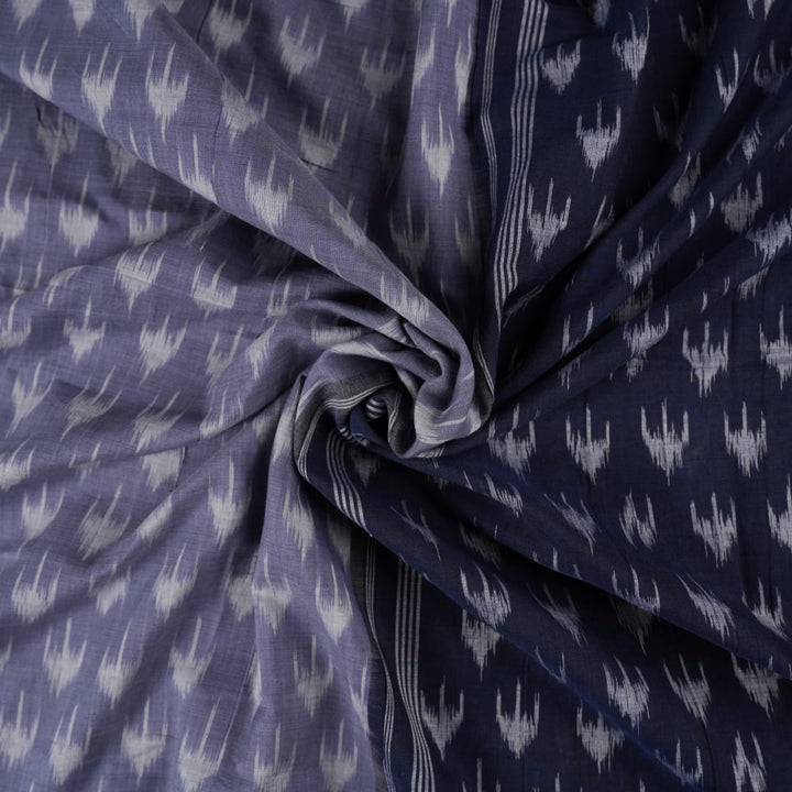 Model wearing a grey and black Sambalpuri cotton saree with traditional ikat motifs in a classic ethnic drape.