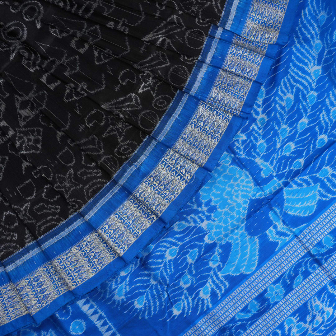 Close-up of Sambalpuri Silk saree fabric, revealing its rich texture and intricate black and blue weave.