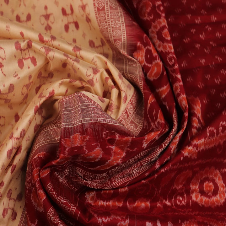 Close-up showcasing the intricate cream and maroon silk fabric texture with Sambalpuri motifs