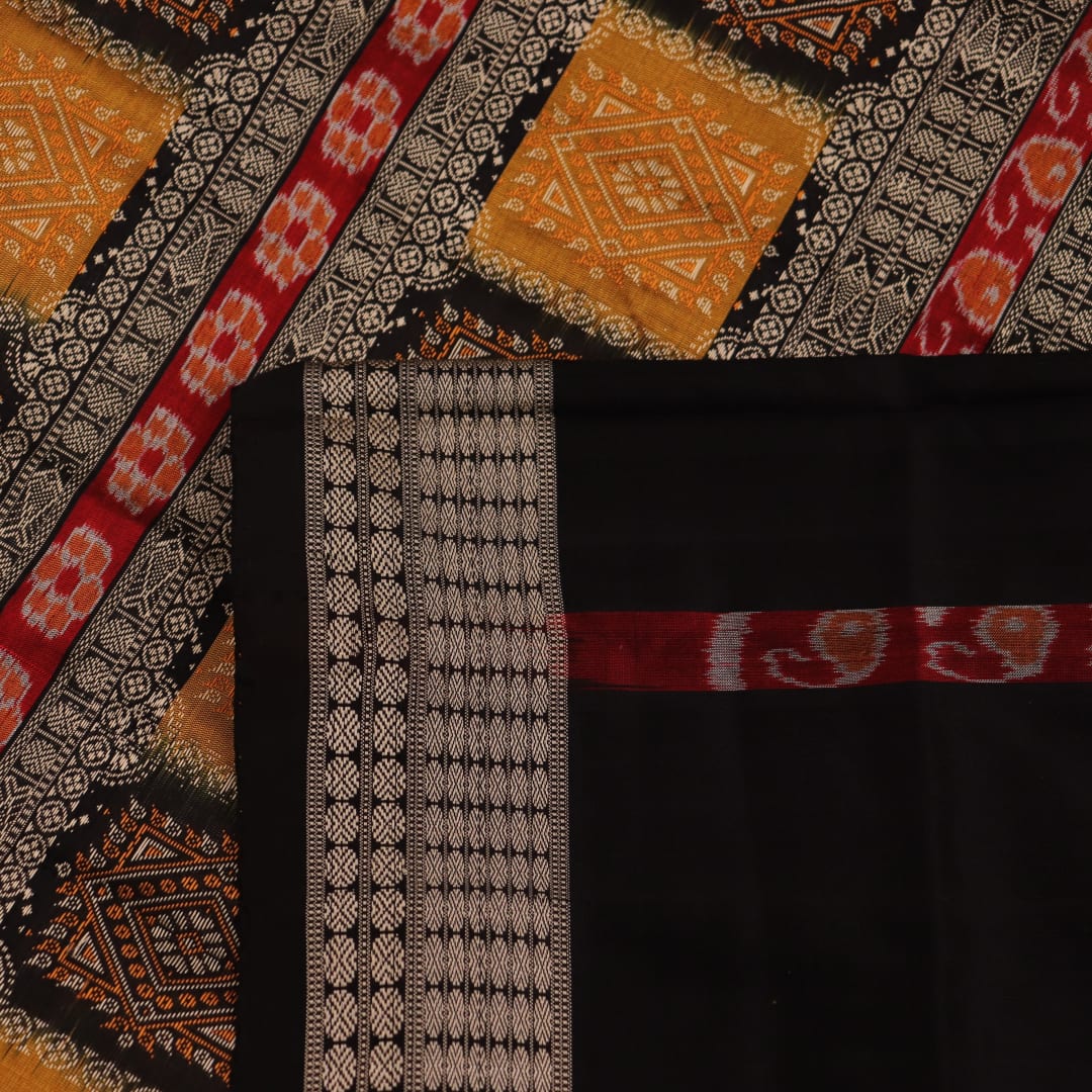 Close-up of yellow silk Bomkai saree fabric with black butta pattern