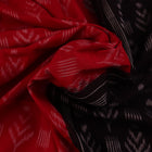Red and black Sambalpuri cotton saree with motifs, elegantly draped to showcase its style and design.