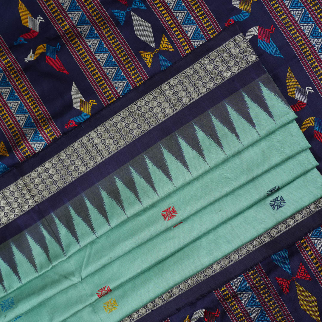 Extreme close-up revealing the rich texture and intricate weave of green Bomkai Silk fabric.