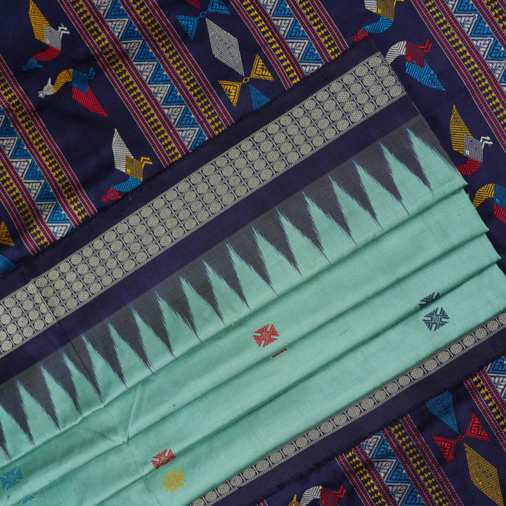 Extreme close-up revealing the rich texture and intricate weave of green Bomkai Silk fabric.