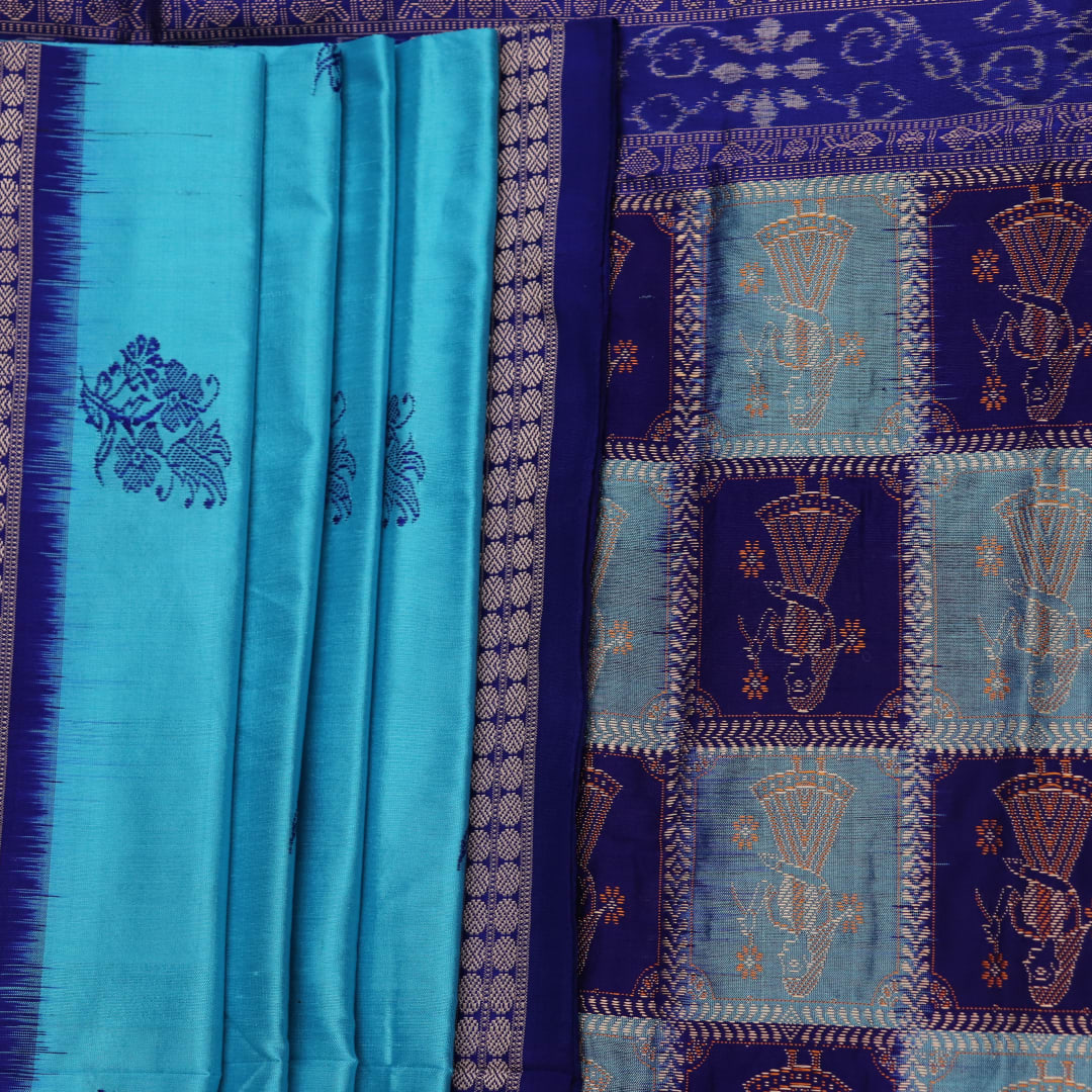 Close-up showcasing the silk texture of a blue and blue Bomkai silk saree with a butta pattern.