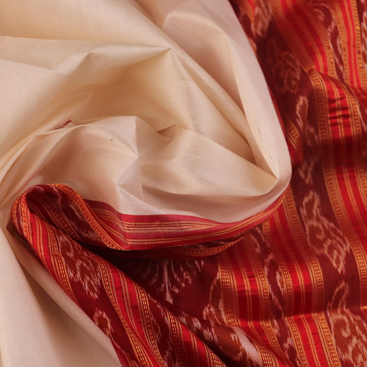 Khandua silk saree styled; white with red butta design, showcasing drape and overall look.