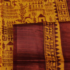 Close-up showing the textured weave of a yellow and brown printed Tussar silk saree.