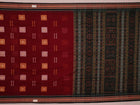 Full view of a maroon cotton Bomkai saree with green butta pattern throughout.