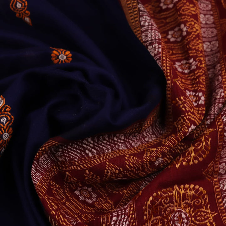 Full view of a blue and maroon Bomkai cotton saree with a butta pattern.