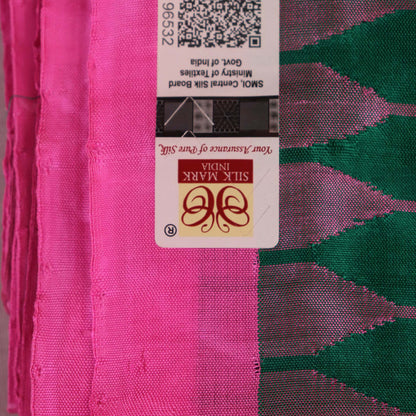 Close-up of plain green and pink Sambalpuri silk saree fabric texture.