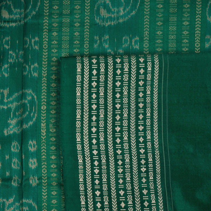 Extreme close-up of the rich orange Sambalpuri silk fabric, highlighting its intricate handloom weave texture.