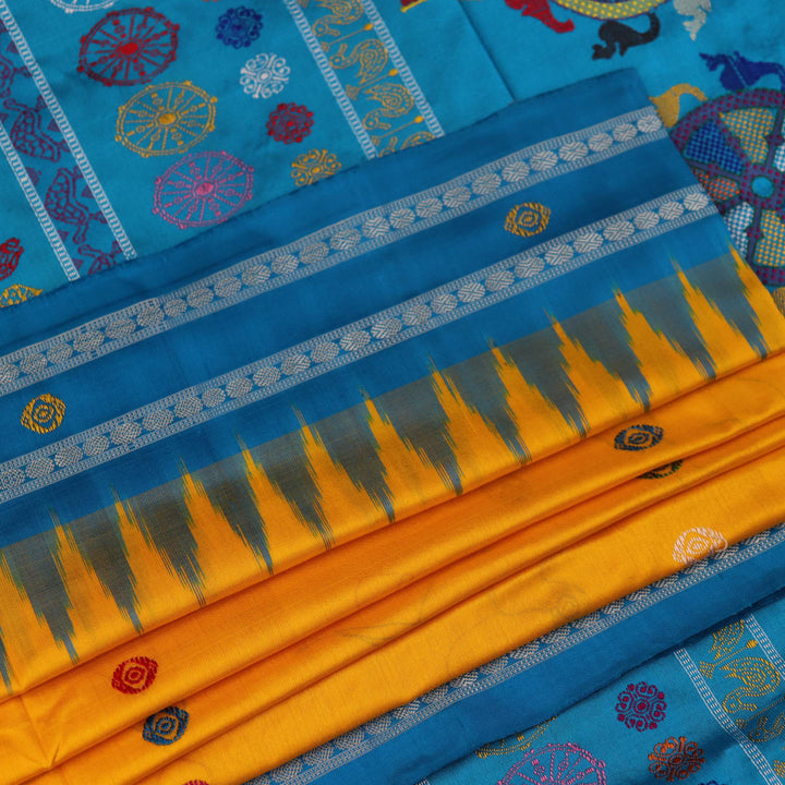 Close-up of the yellow Bomkai silk saree fabric texture, revealing its intricate weave and butta pattern.