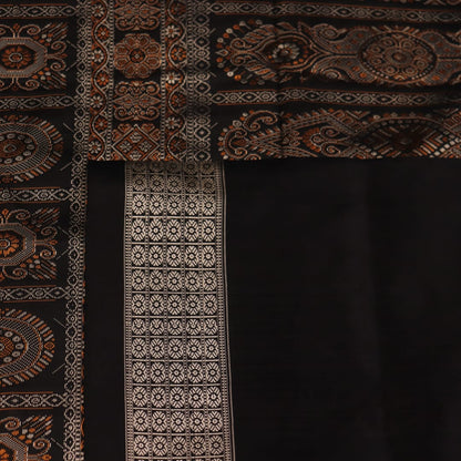 Close-up of the intricate woven texture of blue and black Bomkai silk saree with butta.