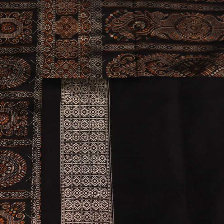 Close-up of the intricate woven texture of blue and black Bomkai silk saree with butta.