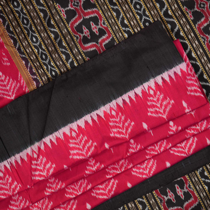 Close-up of the luxurious, handloom silk texture of the red Sambalpuri saree, showing the weave.