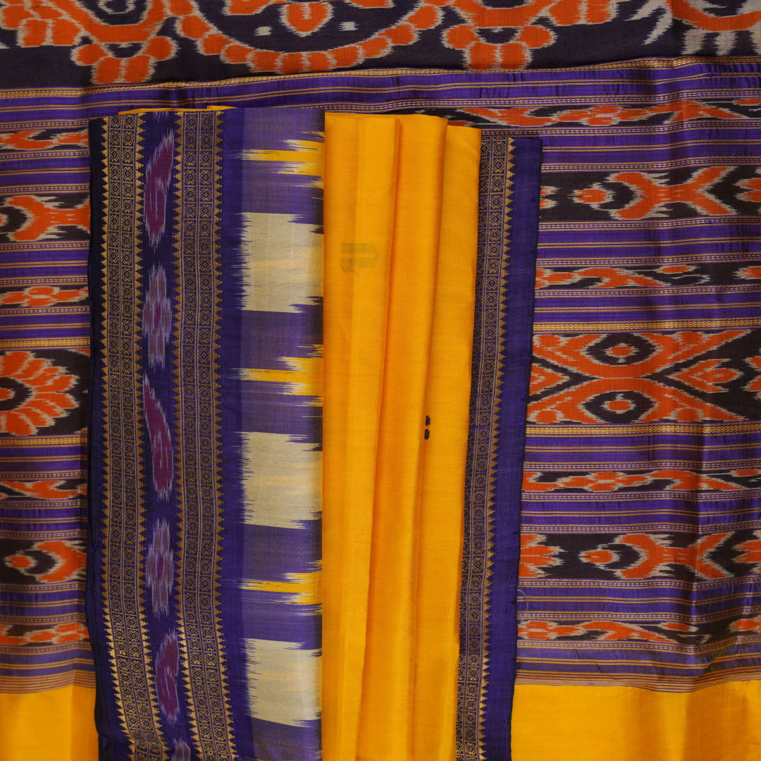 Full styling view of a model draped in a vibrant yellow and blue handloom Khandua silk saree with butta work.
