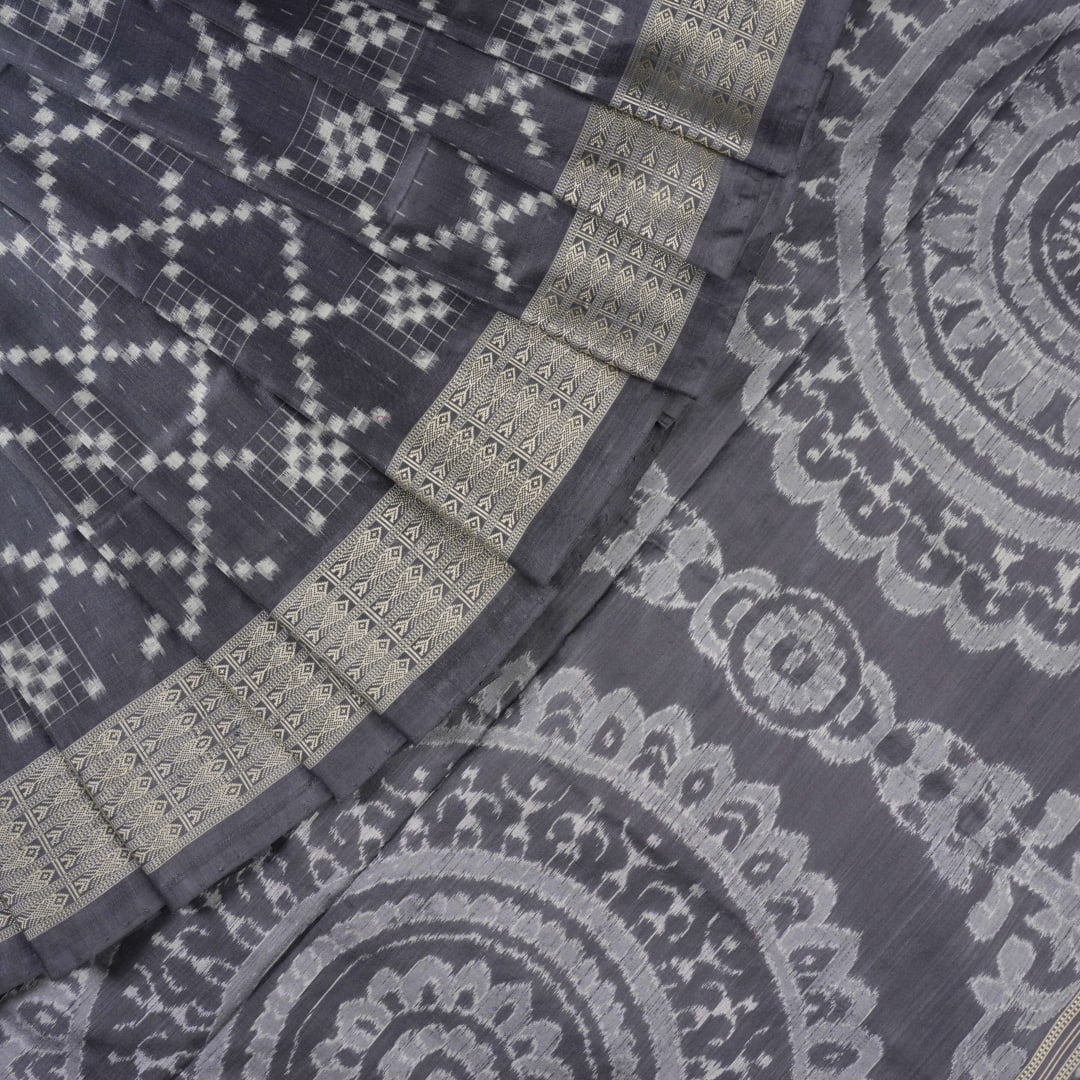 Close-up of the soft, luxurious grey Sambalpuri silk fabric texture with subtle weave details.