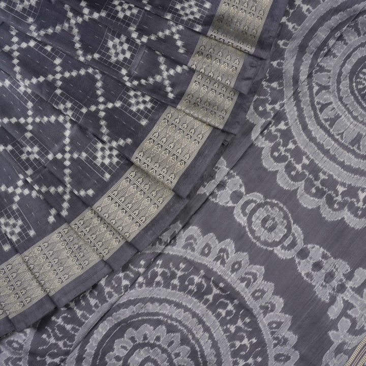 Close-up of the soft, luxurious grey Sambalpuri silk fabric texture with subtle weave details.