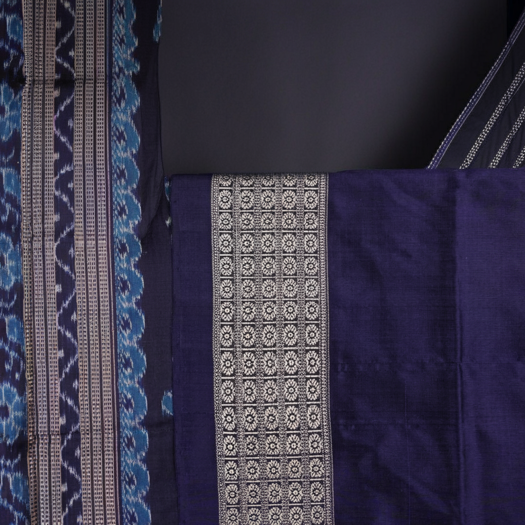 Close-up of the rich silk fabric texture of the Sambalpuri Saree, showing the intricate weave and slight sheen.