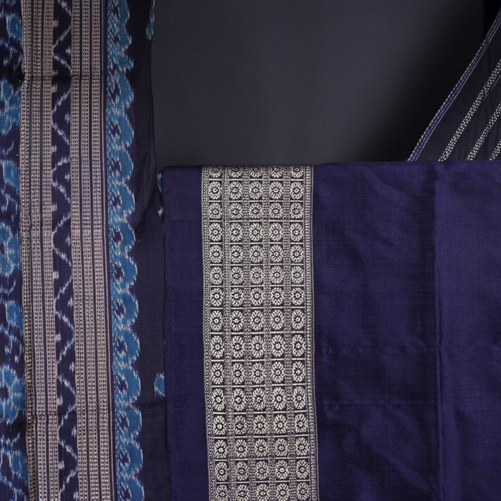 Close-up of the rich silk fabric texture of the Sambalpuri Saree, showing the intricate weave and slight sheen.