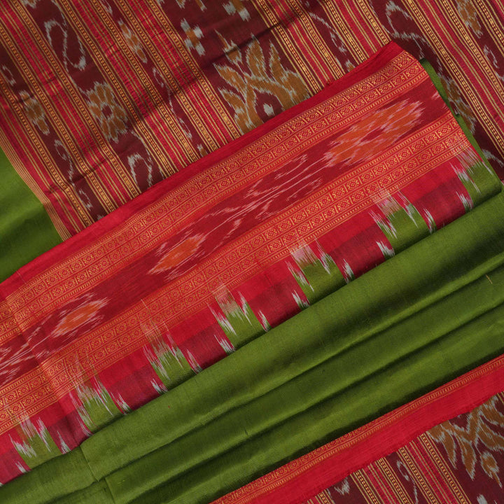 Model draped in a green and red Khandua silk saree with traditional butta work and rich border.