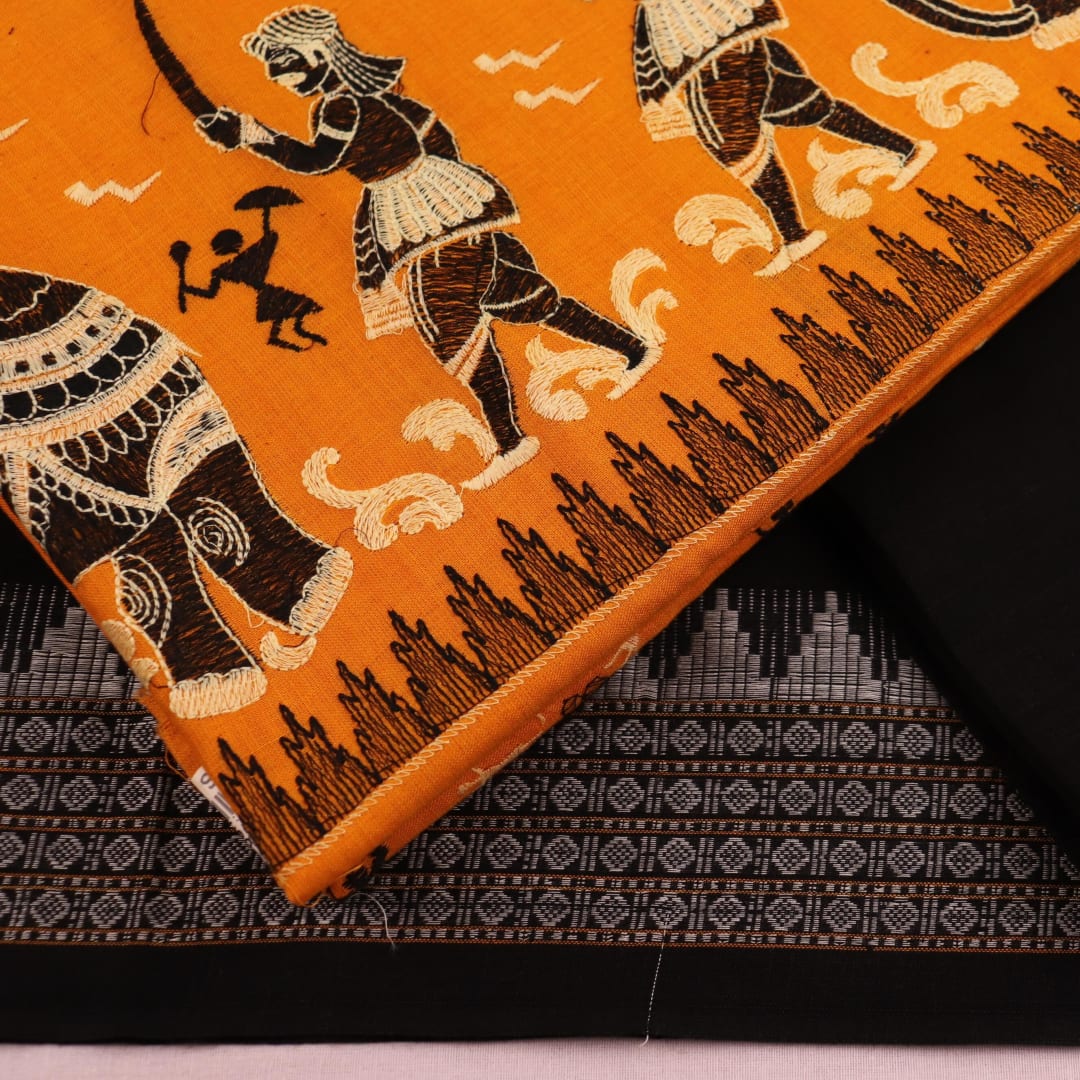 Close-up of blouse piece design featuring a doll pattern in yellow and black cotton Sambalpuri dress material