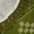 Model wearing a white and green Sambalpuri cotton saree, demonstrating the elegant drape and handloom motifs.