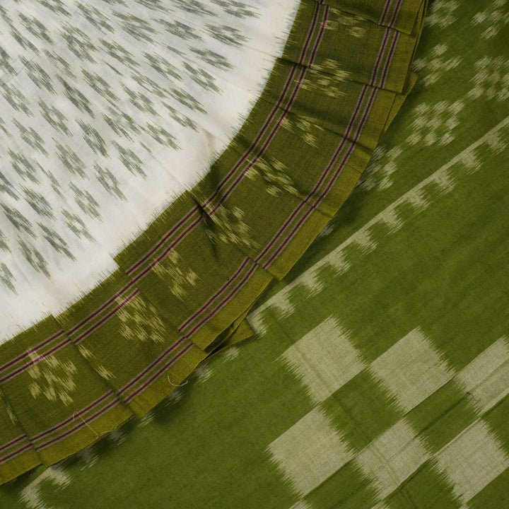 Model wearing a white and green Sambalpuri cotton saree, demonstrating the elegant drape and handloom motifs.