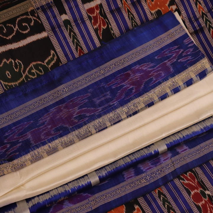 White silk Khandua saree with blue motifs, draped in traditional style