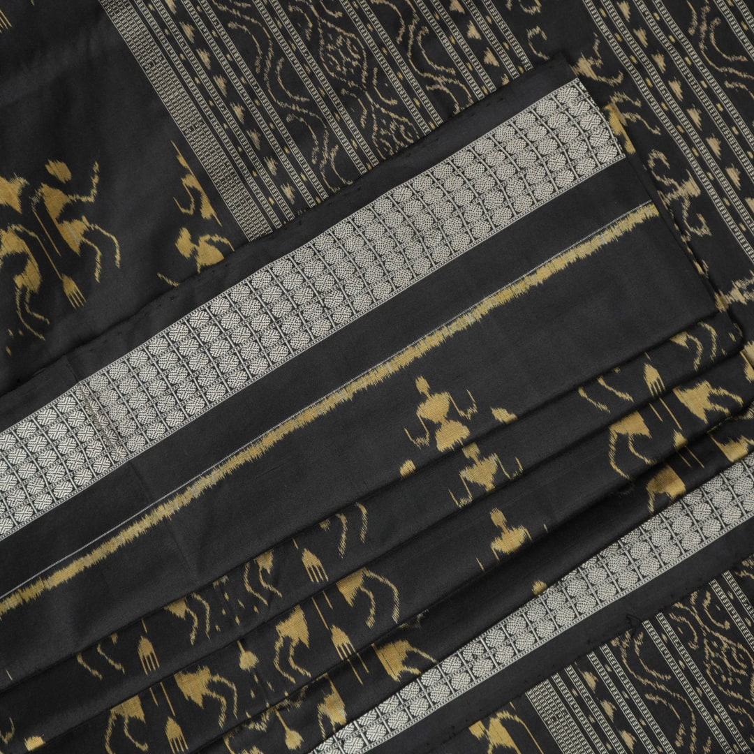 Close-up of the lustrous black Sambalpuri silk fabric, revealing its luxurious texture and fine weave.